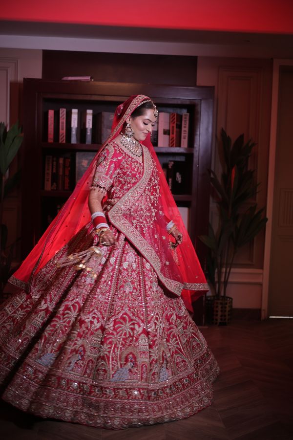 Indian bride wearing a red lehenga and henna