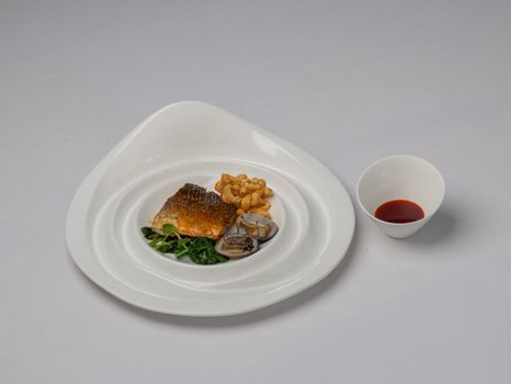 Aesthetic seafood presentation with spinach and sauce in Bodrum, Türkiye.