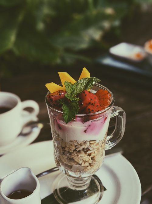 Free Enjoy a refreshing fruit yogurt parfait with granola and fresh mint, perfect for a healthy tropical snack. Stock Photo
