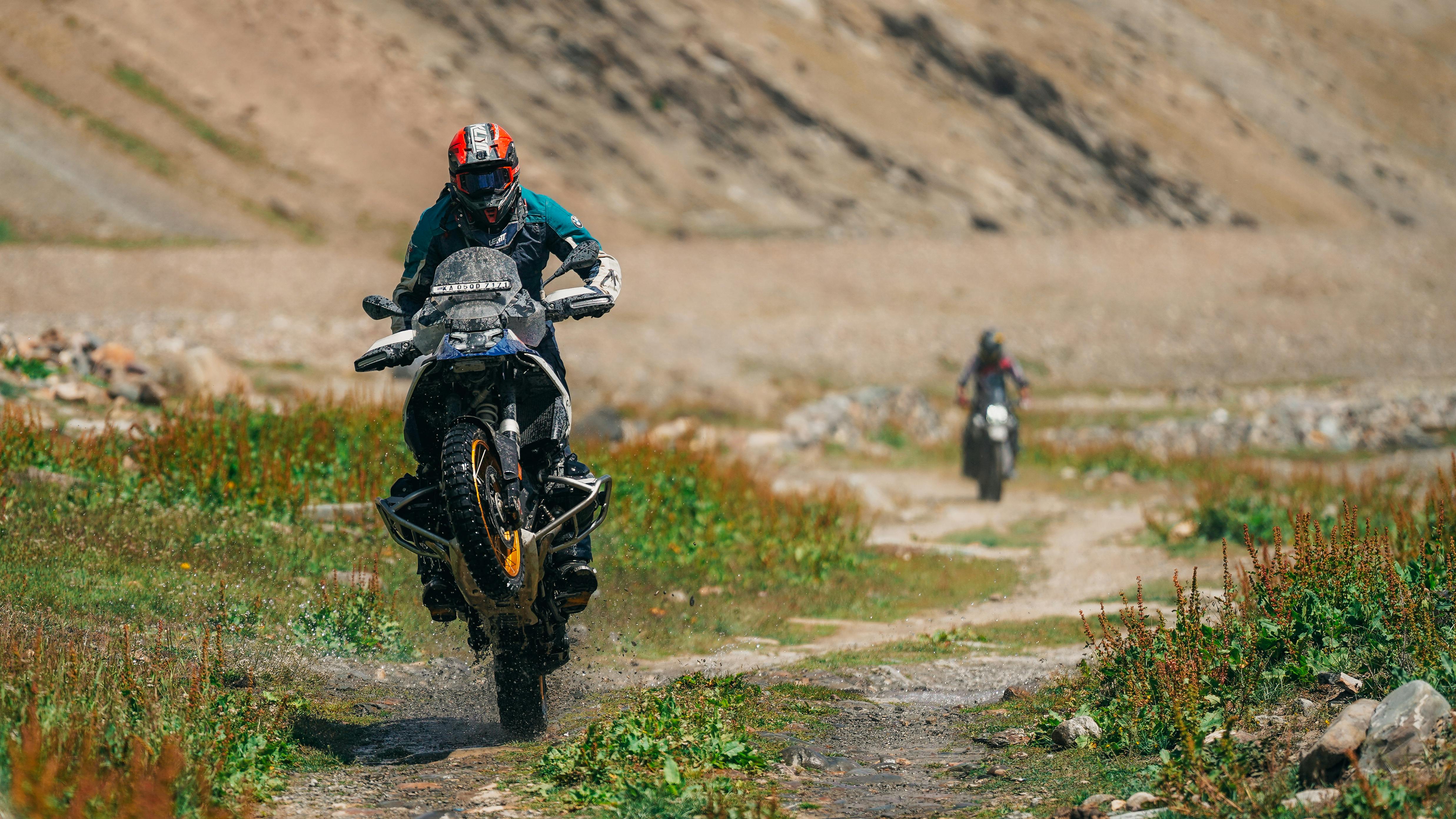 Thrilling off-road motorcycle stunt in a rugged outdoor setting.