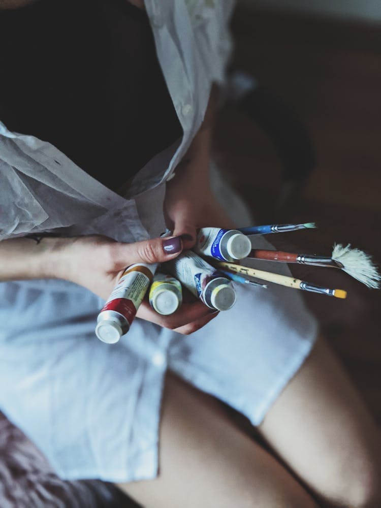 Woman Holding A Paint Brushes And Soft-tubes