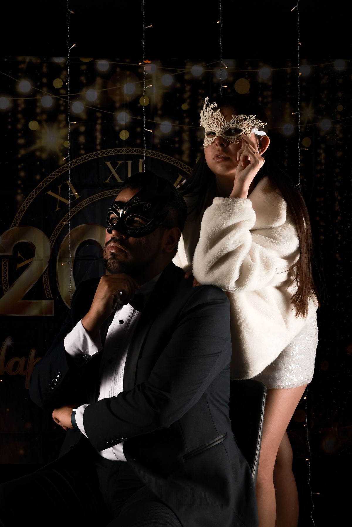 Adult guests in black tie and elegant masquerade masks