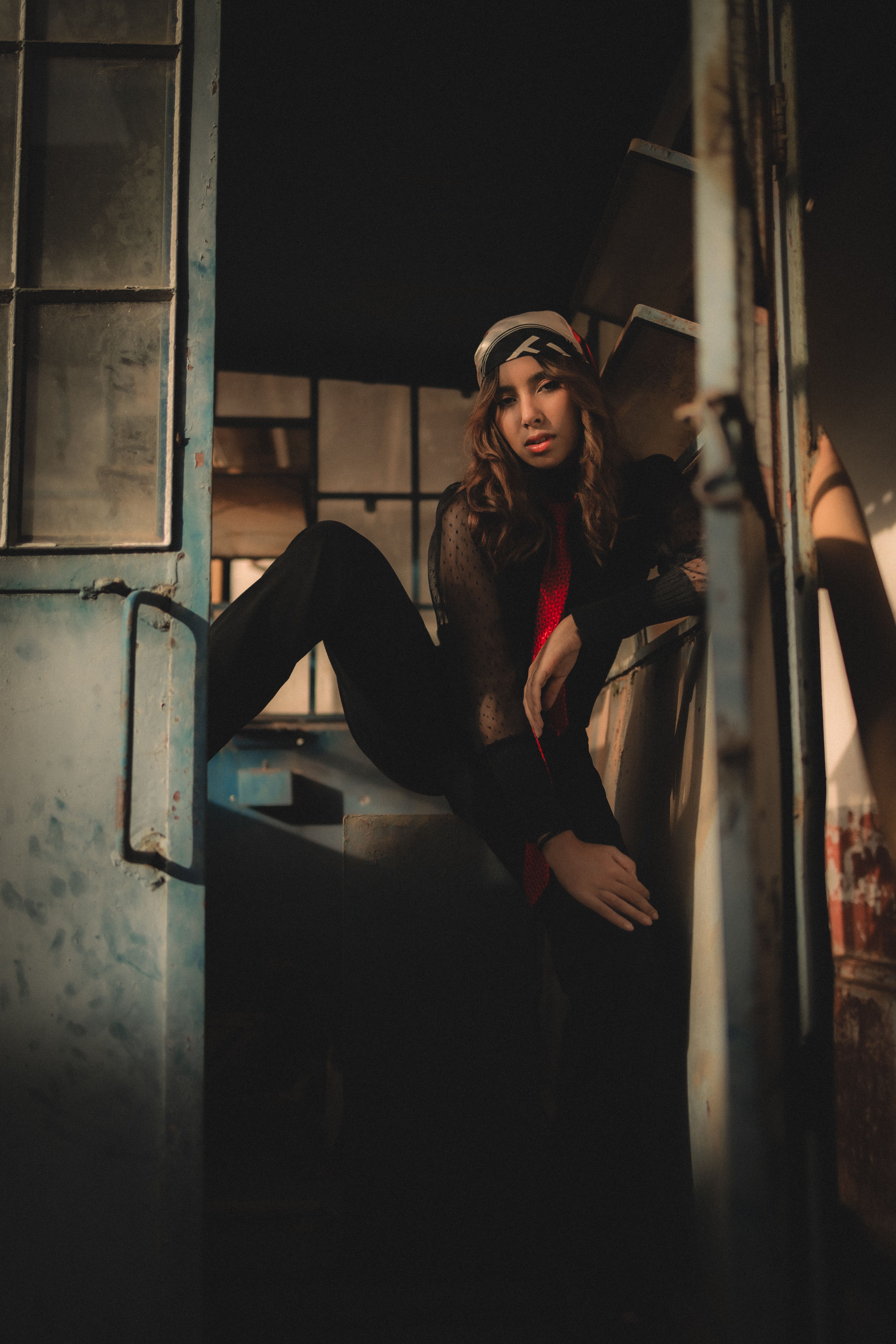 Stylish Woman Posing in Dimly Lit Urban Setting · Free Stock Photo