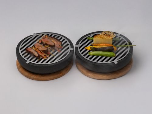 Free Appetizing grilled meals served on stone plates, showcasing exquisite culinary presentation. Stock Photo