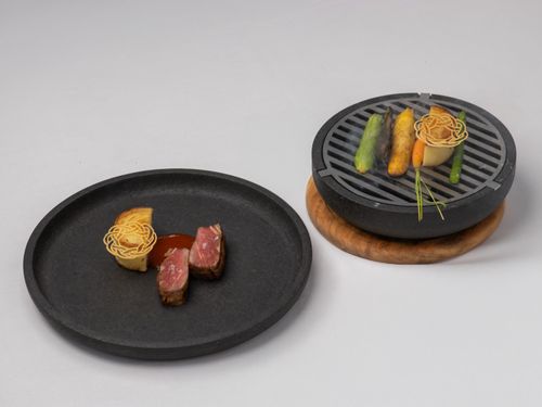 Free Fine dining gourmet dish featuring grilled vegetables and elegantly plated meat. Stock Photo