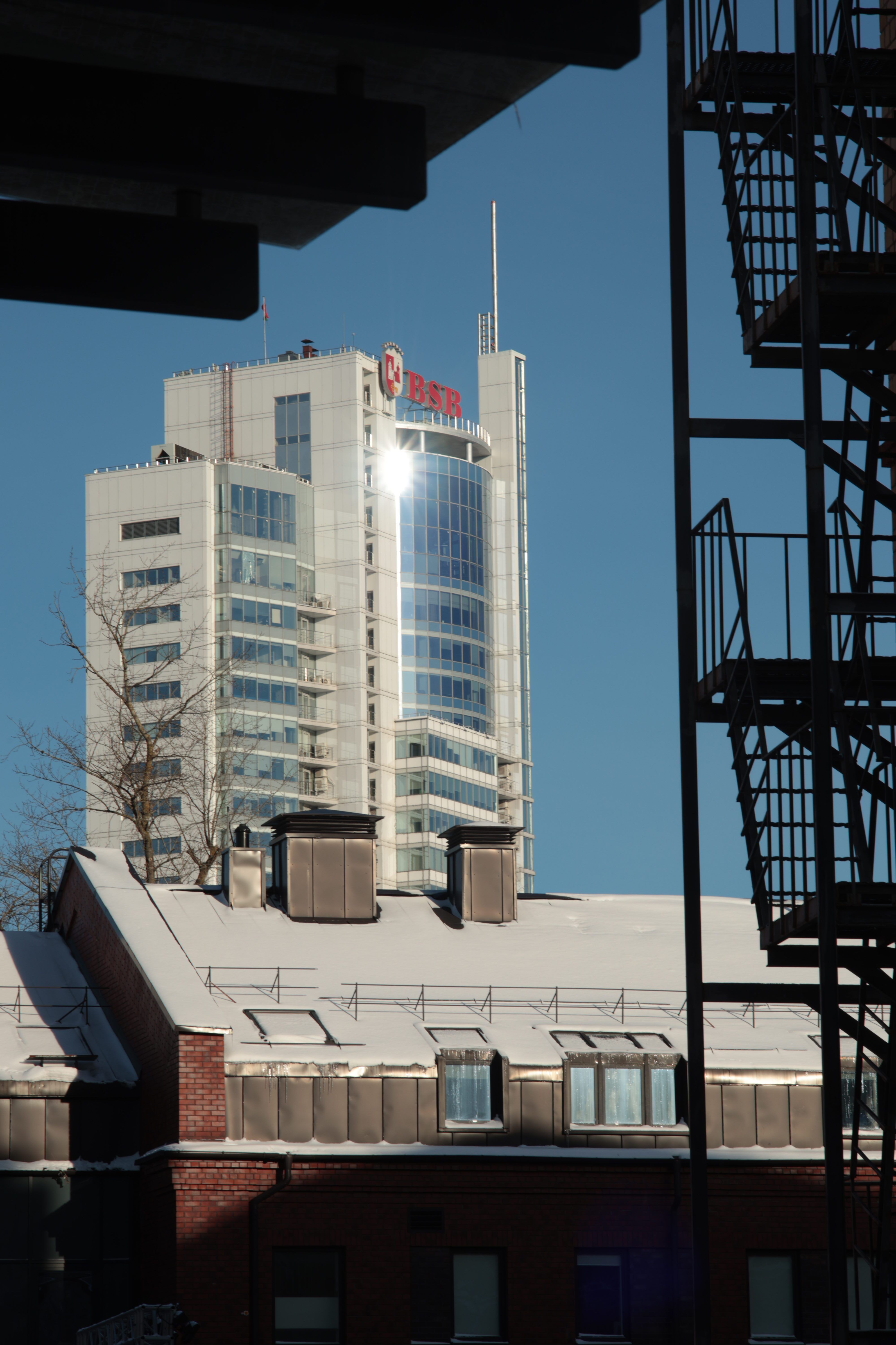 Modern High-Rise Building Under Clear Blue Sky · Free Stock Photo