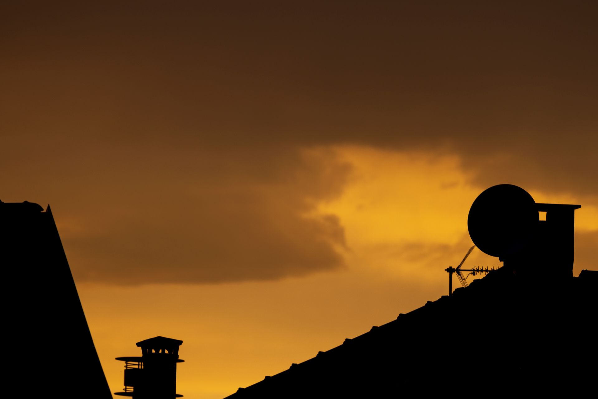 Rooftop satellite dishes over Uran at sunset