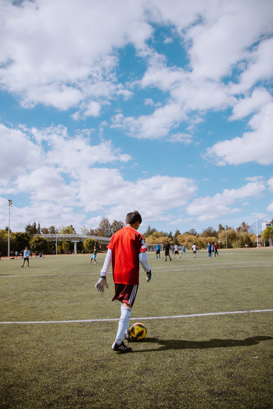 Teen soccer player preparing to kick a ball