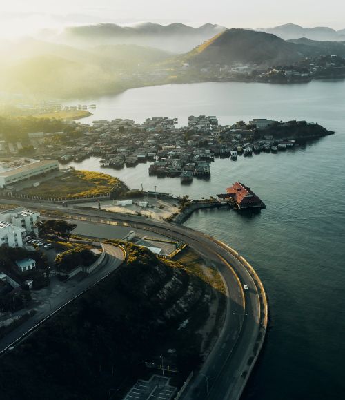 Free A stunning aerial shot of Port Moresby, Papua New Guinea, showcasing coastal roads and sunrise. Stock Photo