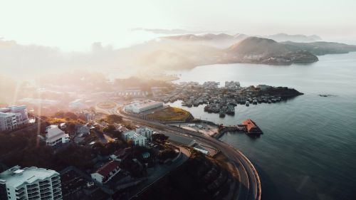 Free Stunning aerial view of Port Moresby at sunrise, showcasing the coastal cityscape and serene sea. Stock Photo
