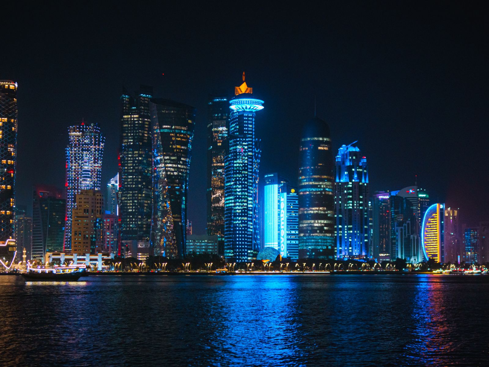 Doha's West Bay skyline lit up at night across the water