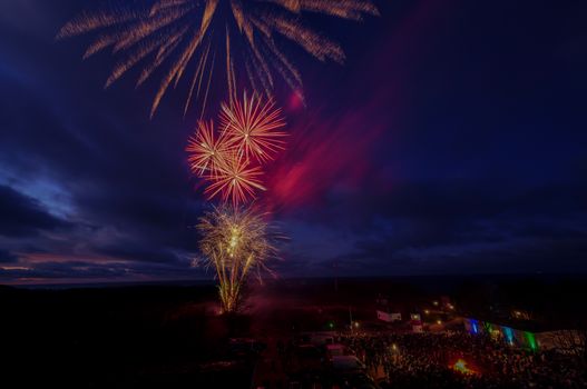 Vibrant fireworks light up the night sky in Putgarten, Germany, celebrating New Year's Eve.