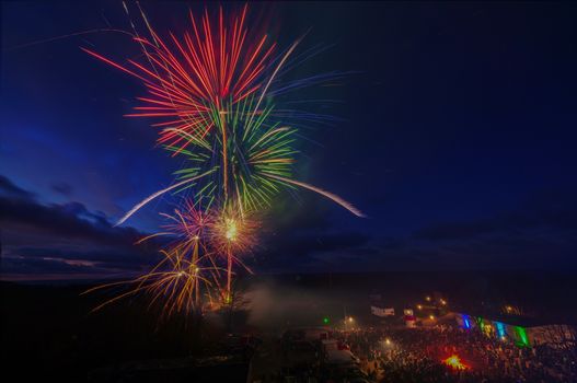 Dazzling fireworks lighting up the night sky celebrating New Year's Eve in Putgarten, Germany.