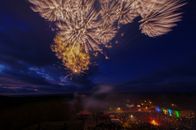 Beautiful fireworks light up the night sky above a crowd in Putgarten, Germany.