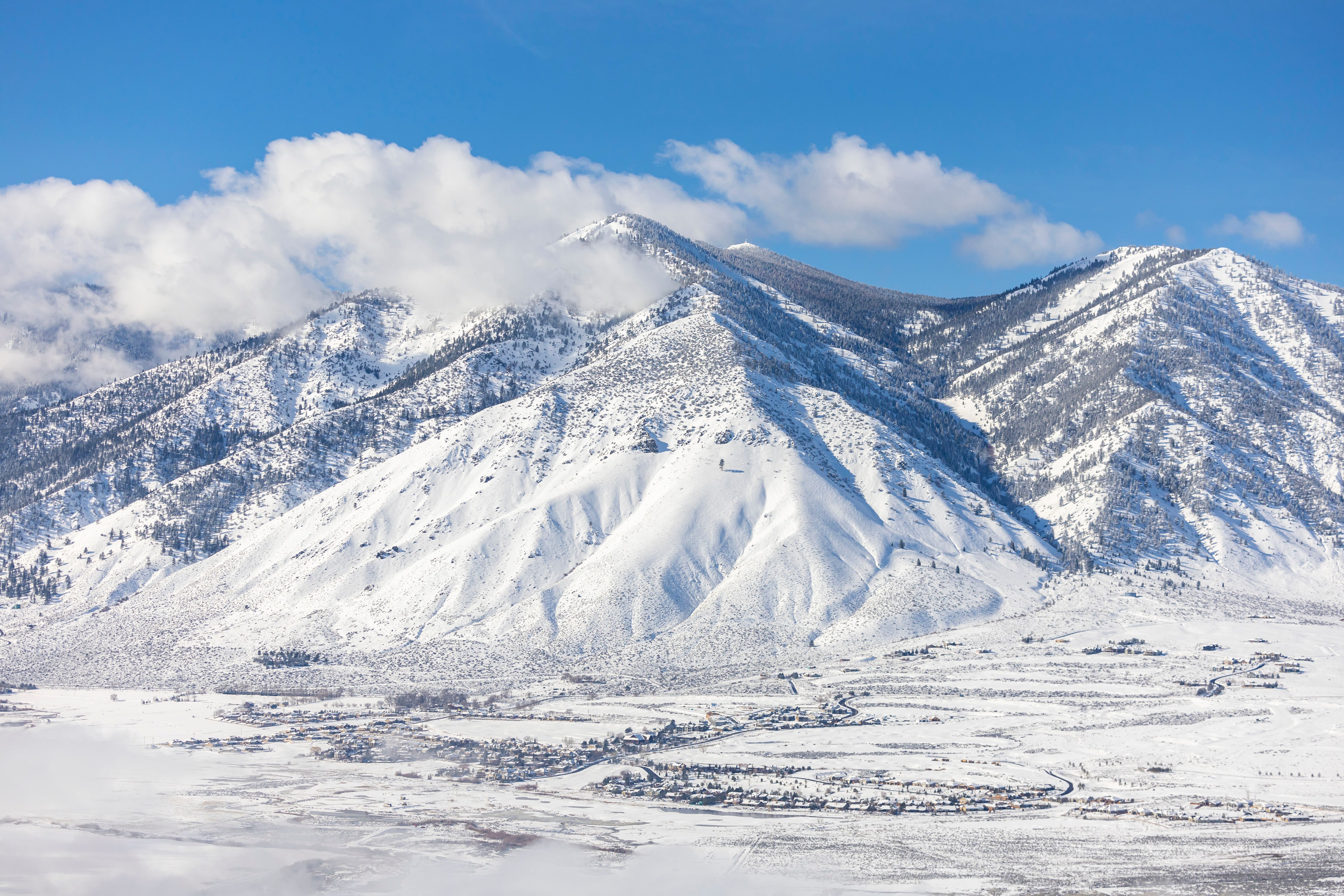 Snow-Covered Mountains Under a Clear Blue Sky · Free Stock Photo