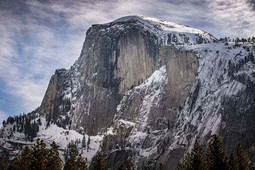 Snow-covered Half Dome in Yosemite National Park on a crisp winter day.
