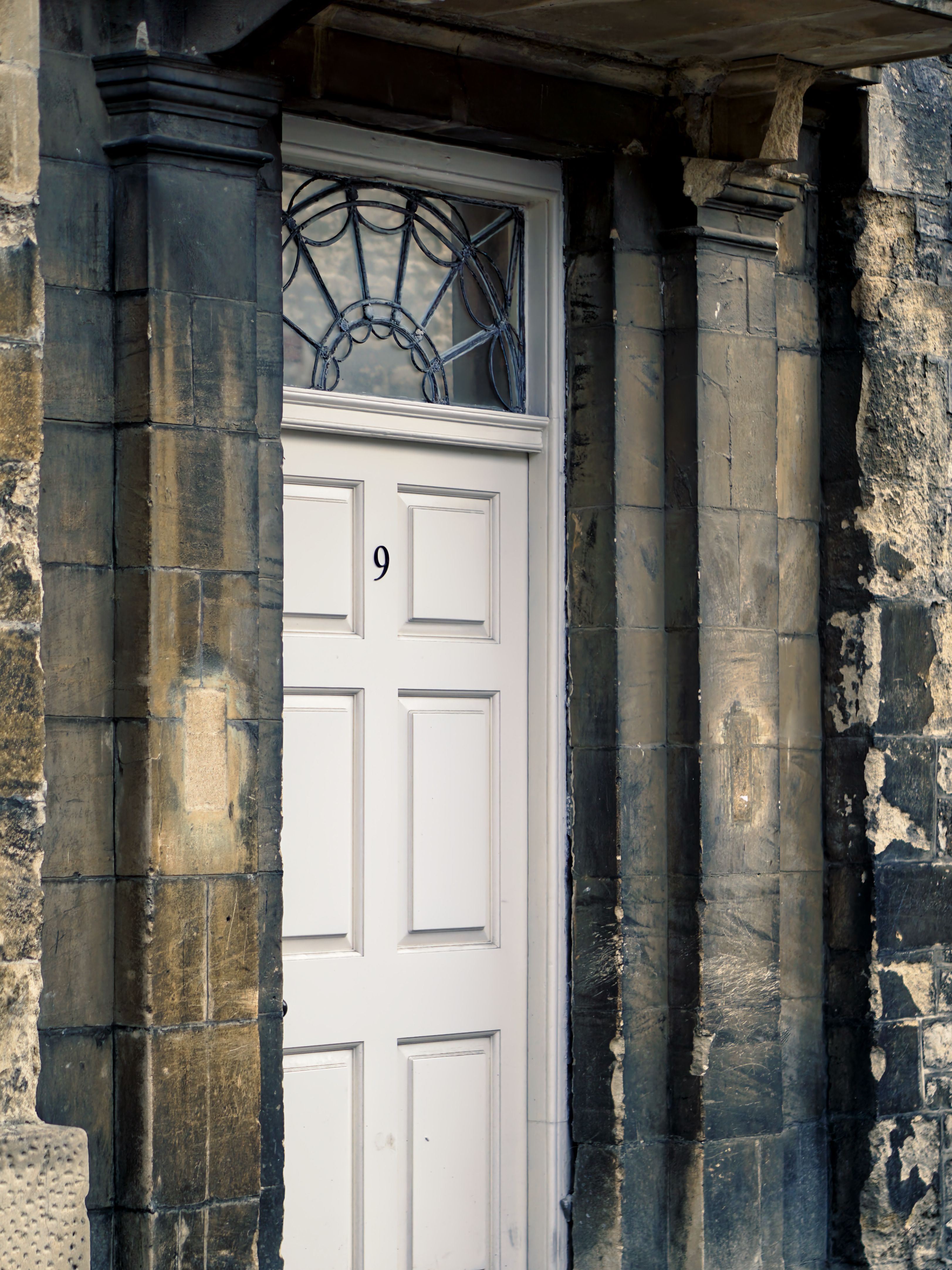 Elegant historic door and stone facade in Oxford, England.