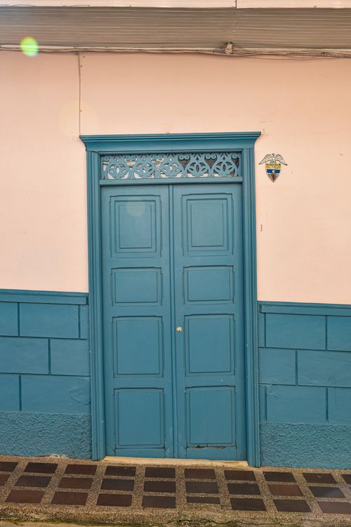 Free Traditional blue door on vibrant building facade in Jericó, Colombia's colorful town. Stock Photo