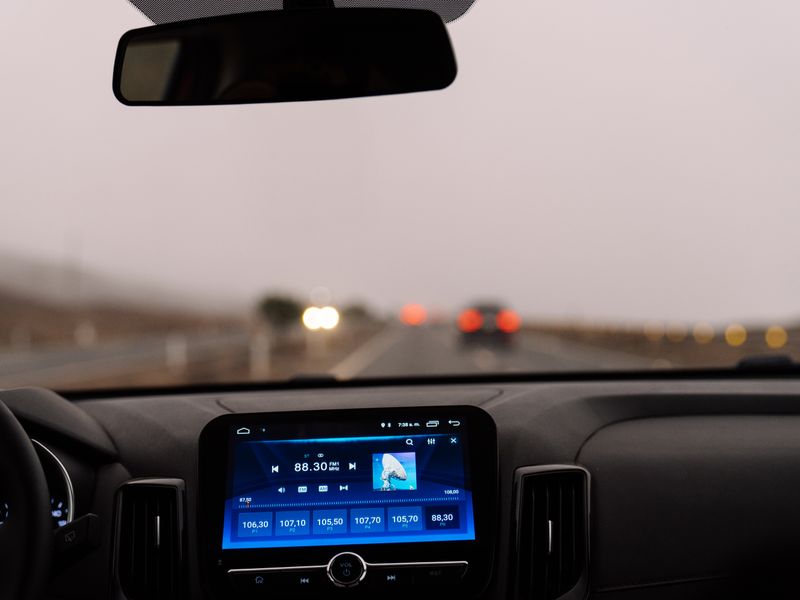 Car dashboard view on an open road representing RTA services
