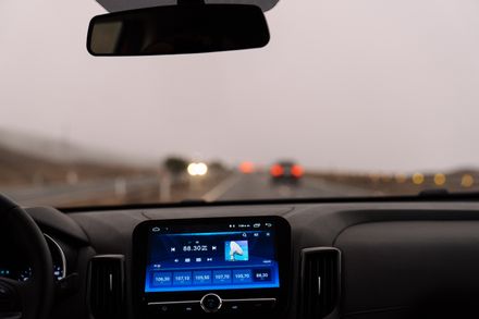View over a car dashboard on an open road — photo by Axel Sandoval on Pexels