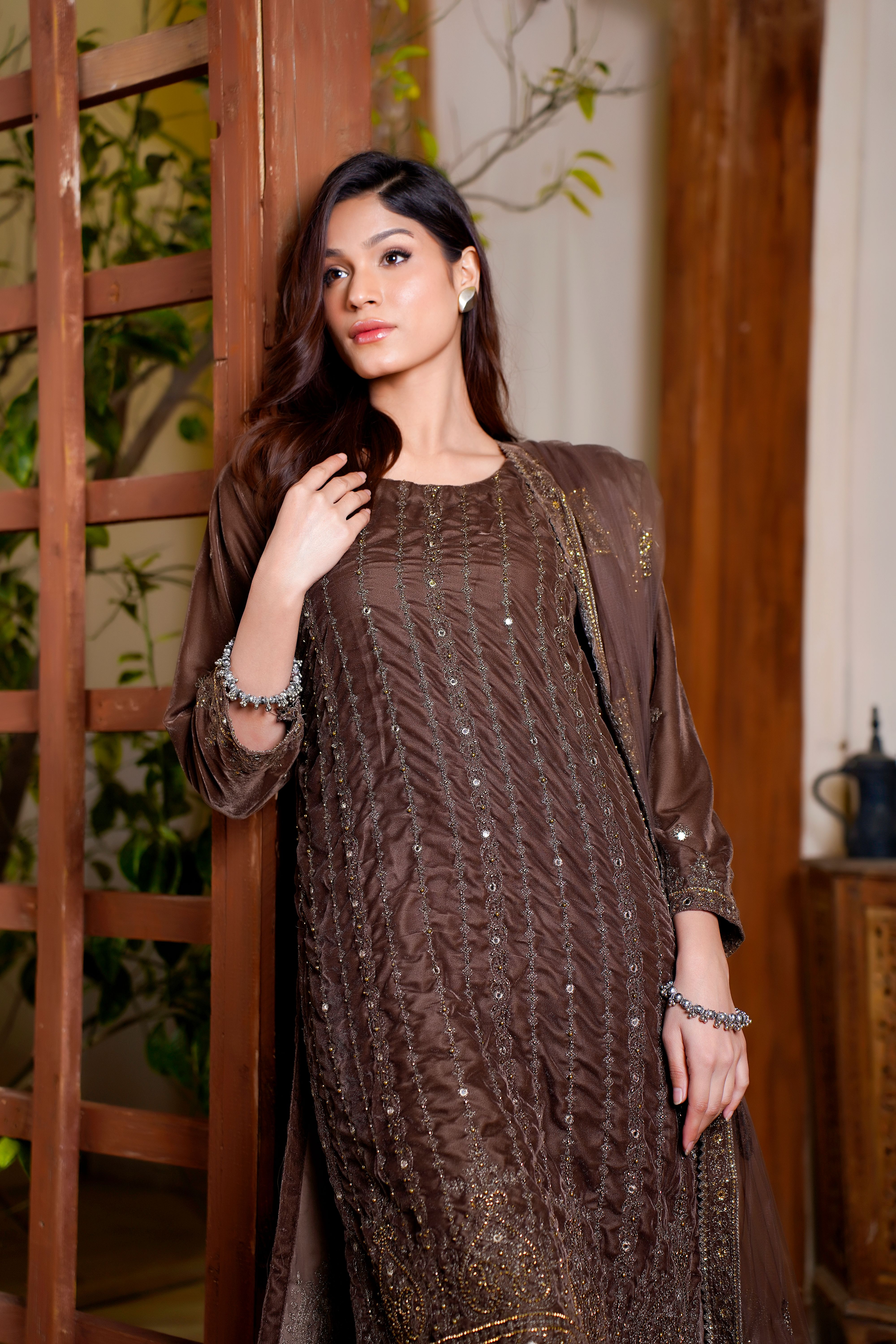 Portrait of a model in a brown traditional dress, indoors, Lahore setting. - How to Shop Online Effectively for Ladies Dresses