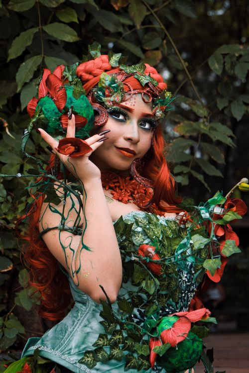 Free Captivating cosplay woman in nature, adorned with leaves, flowers, and makeup. Stock Photo