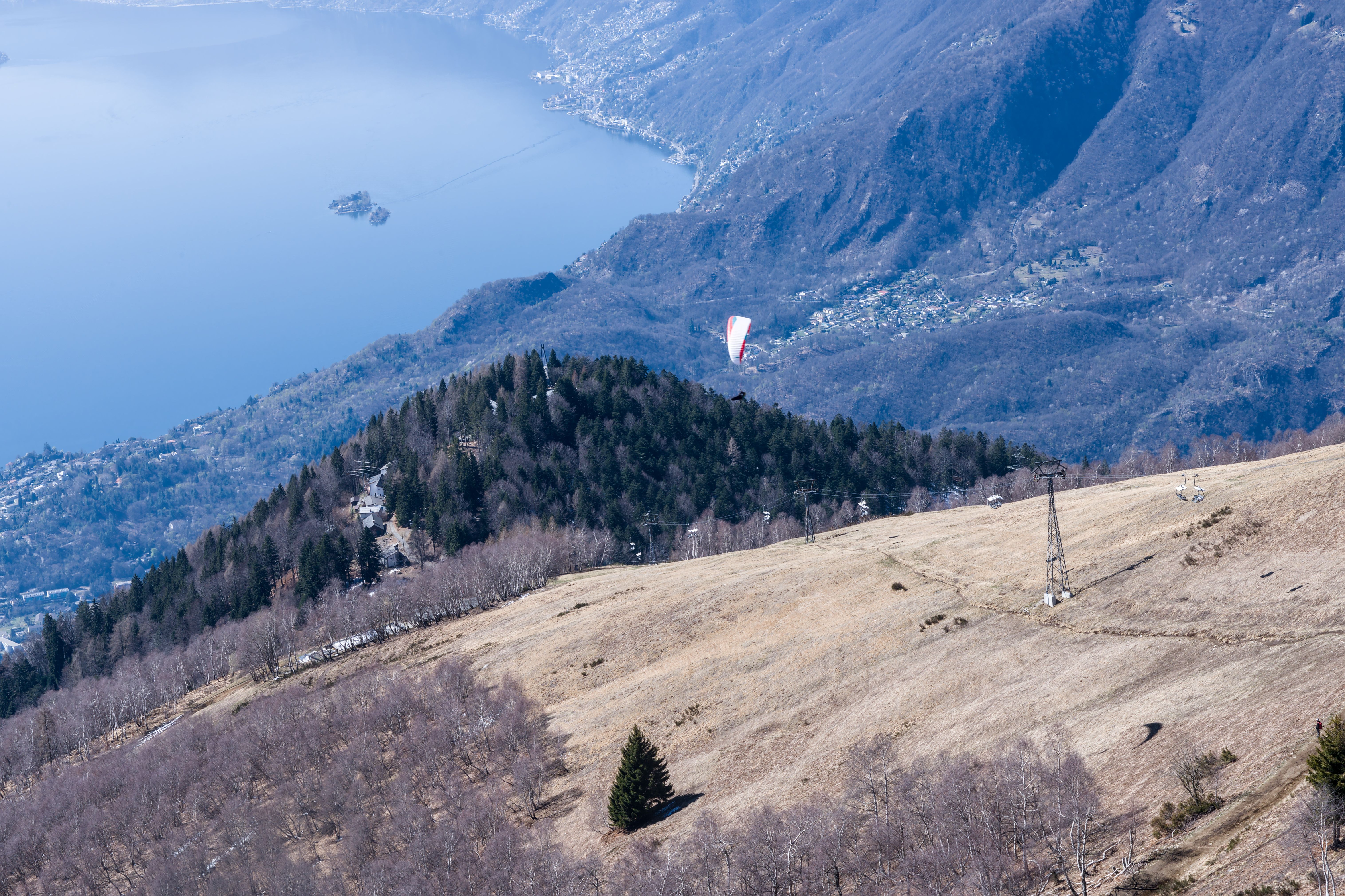Stunning aerial view of the Swiss Alps landscape with paragliding over Lake Maggiore