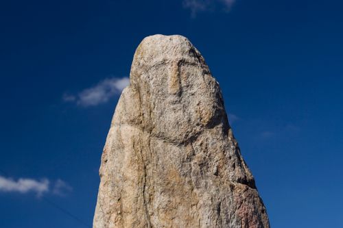 Free A striking stone formation set against a clear blue sky. Perfect for nature and geology themes. Stock Photo