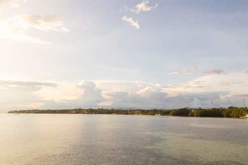 Free A tranquil sunset view over Moalboal's coastline in Cebu, Philippines. Stock Photo