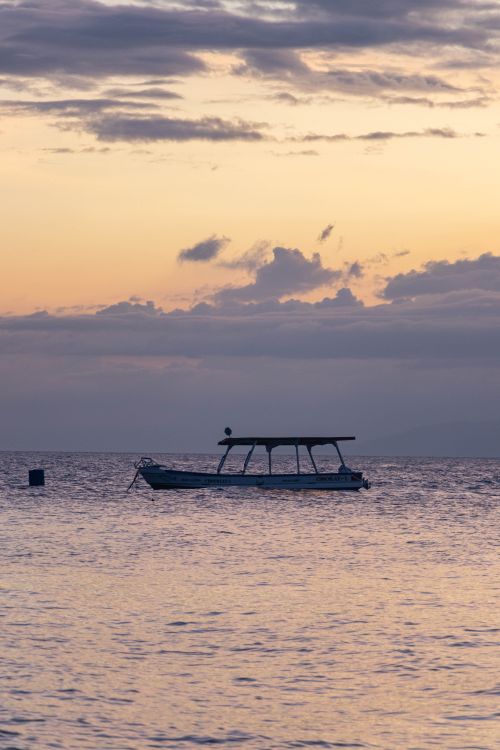 Free A tranquil boat resting on calm waters during sunset in Moalboal, Central Visayas, Philippines. Stock Photo