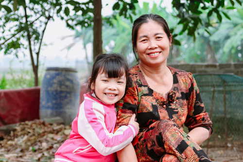 Free Smiling mother and daughter enjoy quality time in a vibrant outdoor setting. Stock Photo