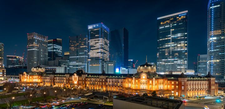 Stunning night view of Tokyo Station with towering skyscrapers in Chiyoda City, Tokyo.