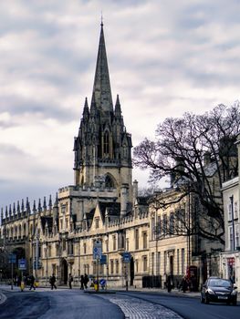 View of the gothic architecture of St Mary's Church in Oxford, England with a cloudy sky.