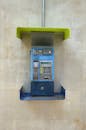 Vintage Wall-Mounted Payphone with Minimalist Design