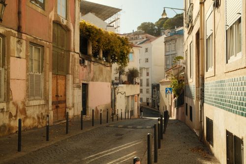 Free Explore a picturesque street in Lisbon, capturing its historic charm and beautiful architecture. Stock Photo
