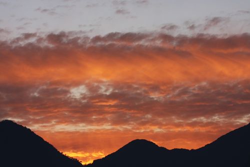 Free Breathtaking sunset view over the mountains in Himachal Pradesh, India, capturing vibrant orange hues. Stock Photo