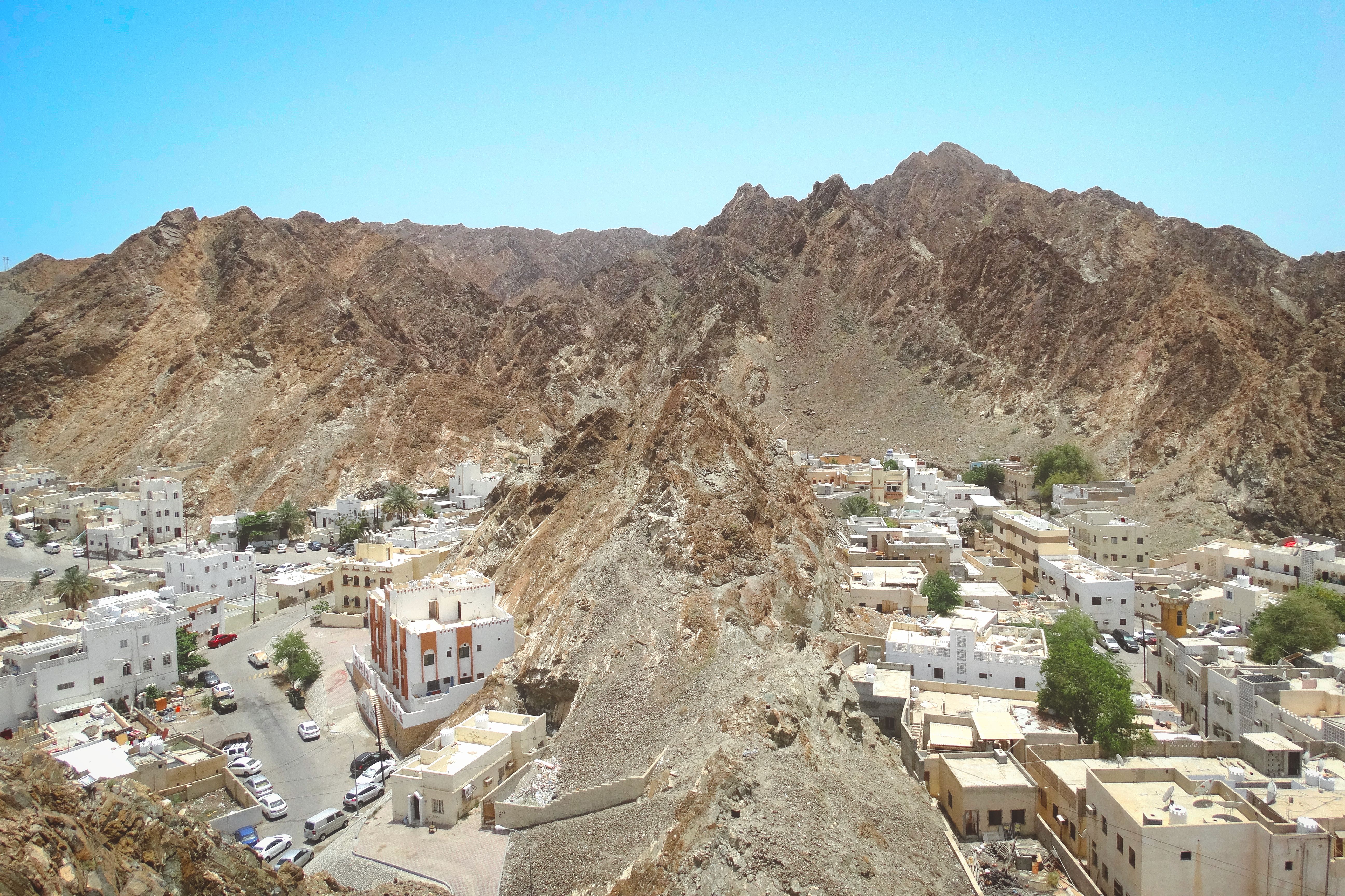 Aerial View of Maskat's Rugged Terrain and Architecture · Free Stock Photo