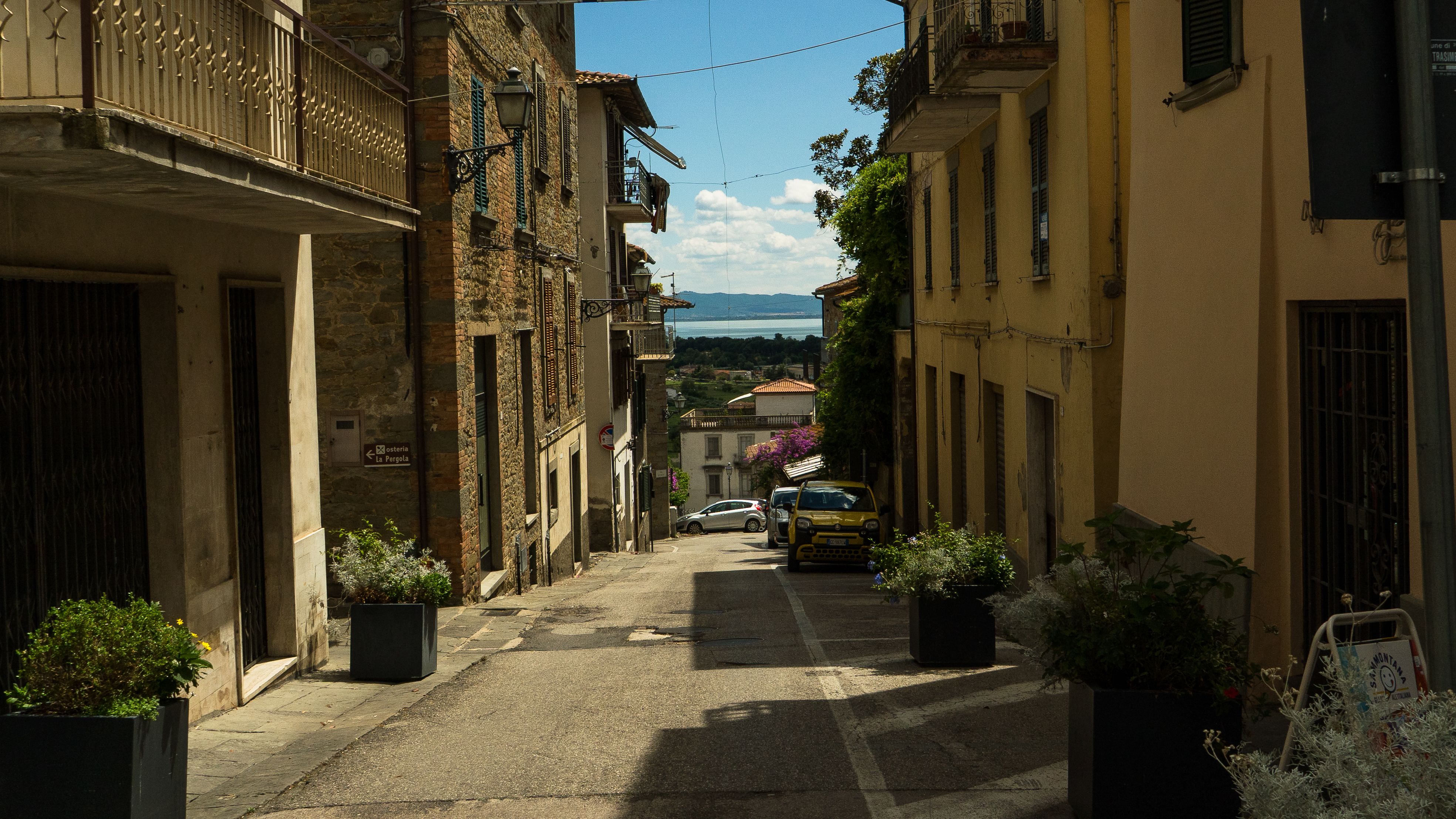 Picturesque street with view of Lake Trasimeno in Tuoro sul Trasimeno, Italy.
