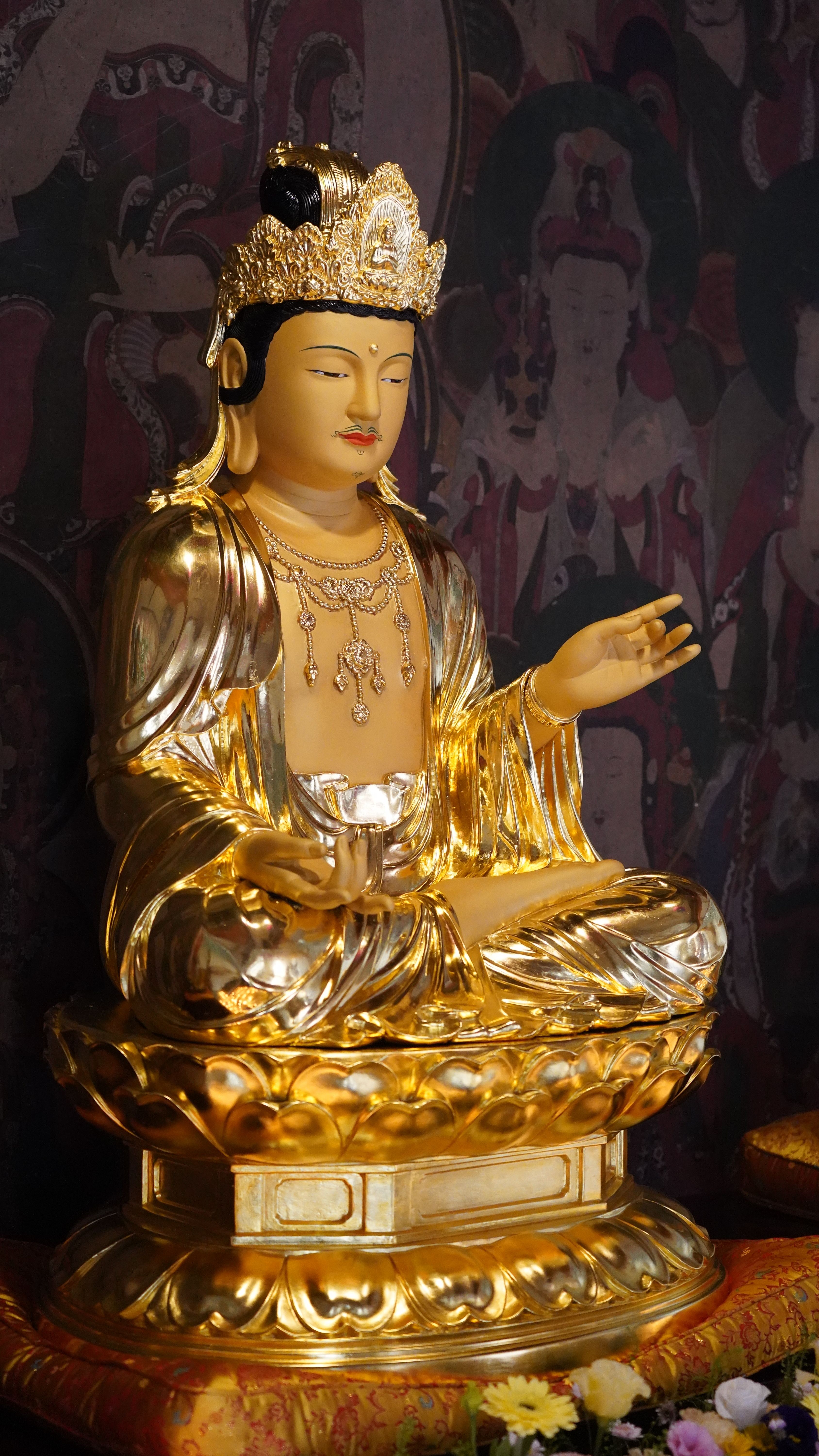 Golden Buddha statue with ornate details in a Korean temple setting, evoking serenity.