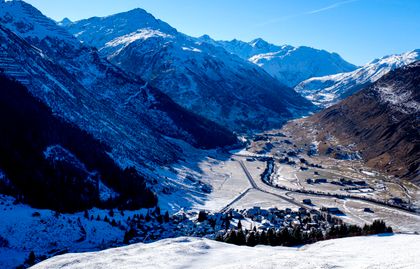 Snow-covered valley between alpine ridges — photo by pierre matile on Pexels