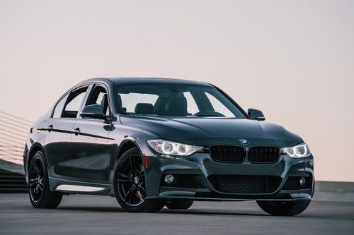 Free Stylish black sedan captured outdoors at sunset with a sleek design and modern appeal. Stock Photo