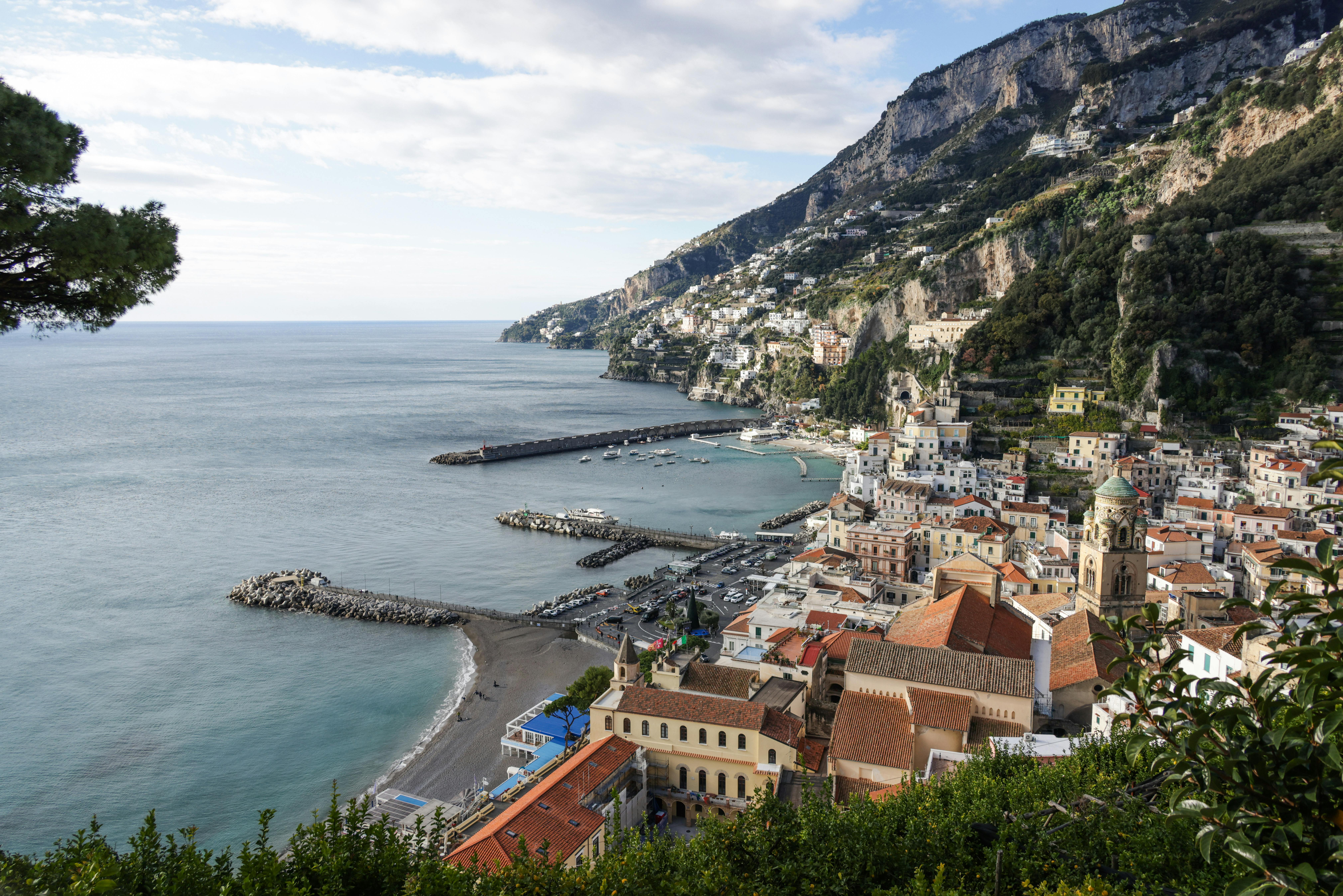 Breathtaking view of Amalfi's charming coastline with colorful buildings and Mediterranean Sea.