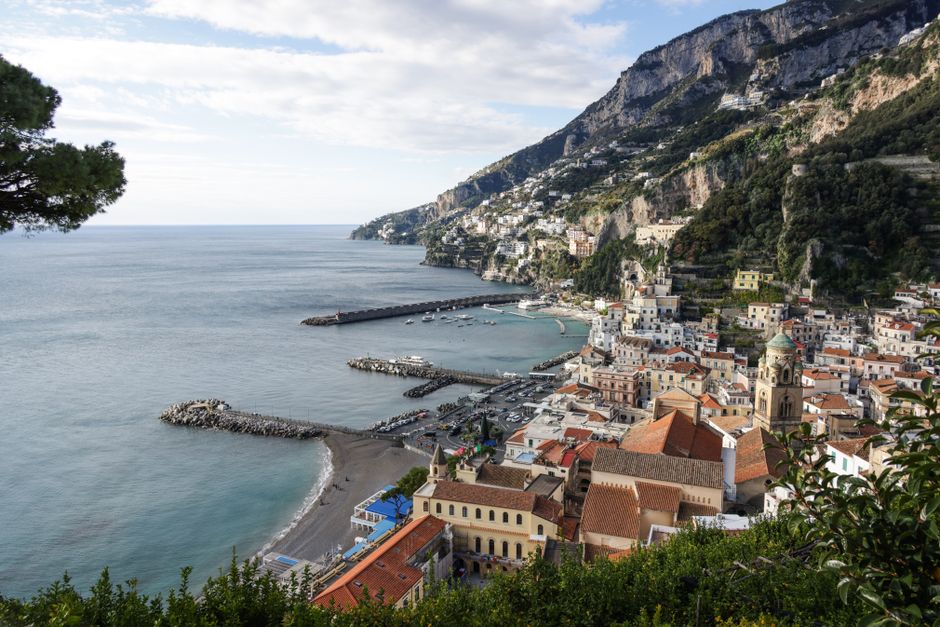 Breathtaking view of Amalfi's charming coastline with colorful buildings and Mediterranean Sea.
