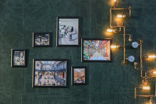Assorted Paintings on Green Wall