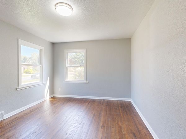 Bright empty room with hardwood-style flooring