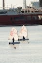 Sailboats in Harbor with Large Ship in Background