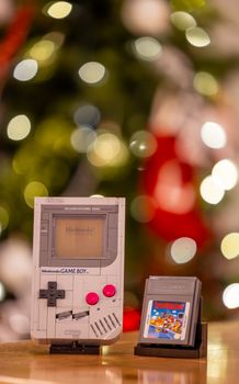 Classic Nintendo Game Boy with a Super Mario cartridge, festive bokeh background.