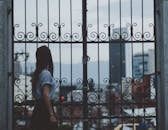 Woman Standing Beside Gate