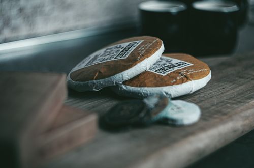 Free A moody close-up of traditional compressed tea cakes on a wooden surface, evoking a sense of calm. Stock Photo
