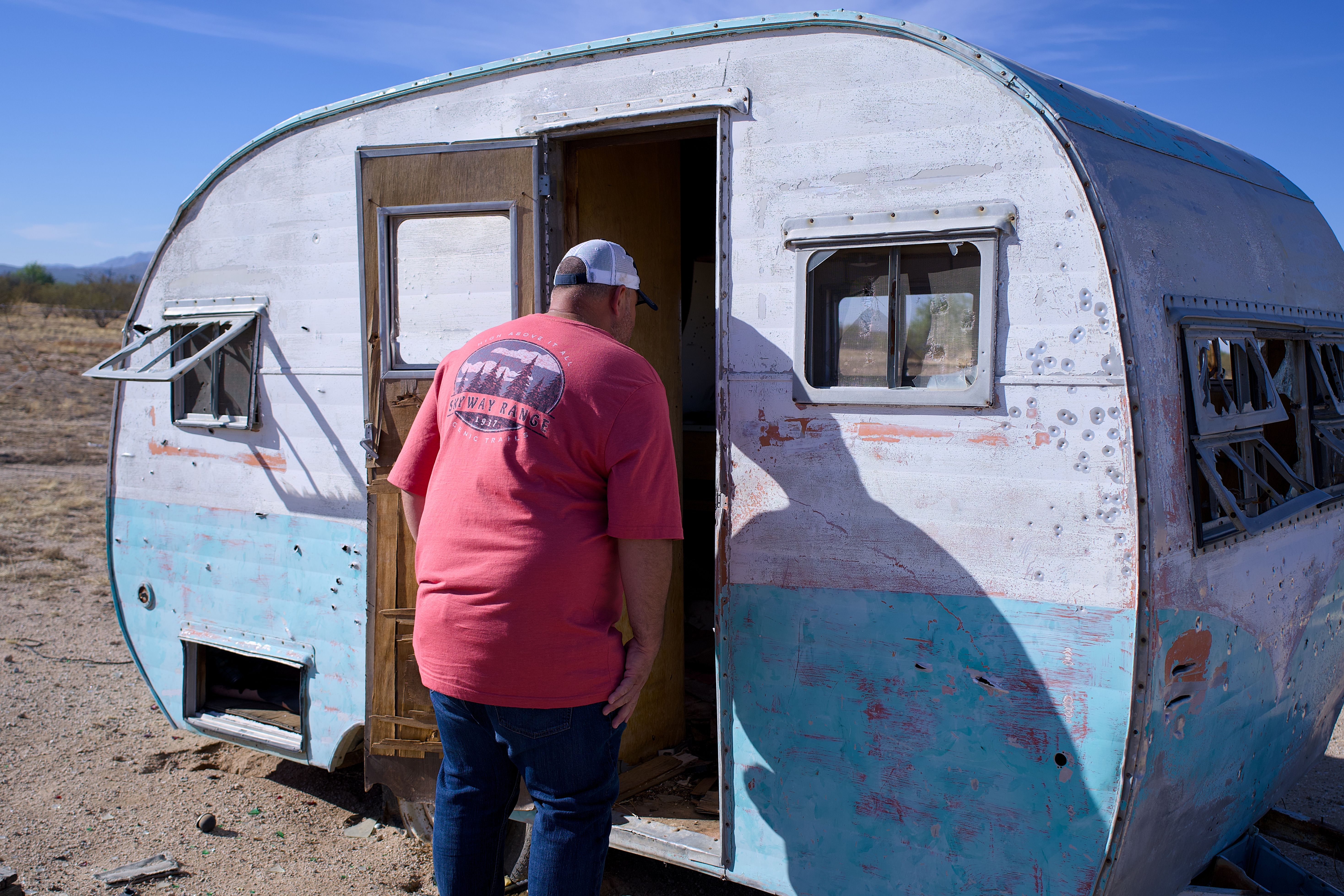 Man Exploring Abandoned Vintage Camper · Free Stock Photo